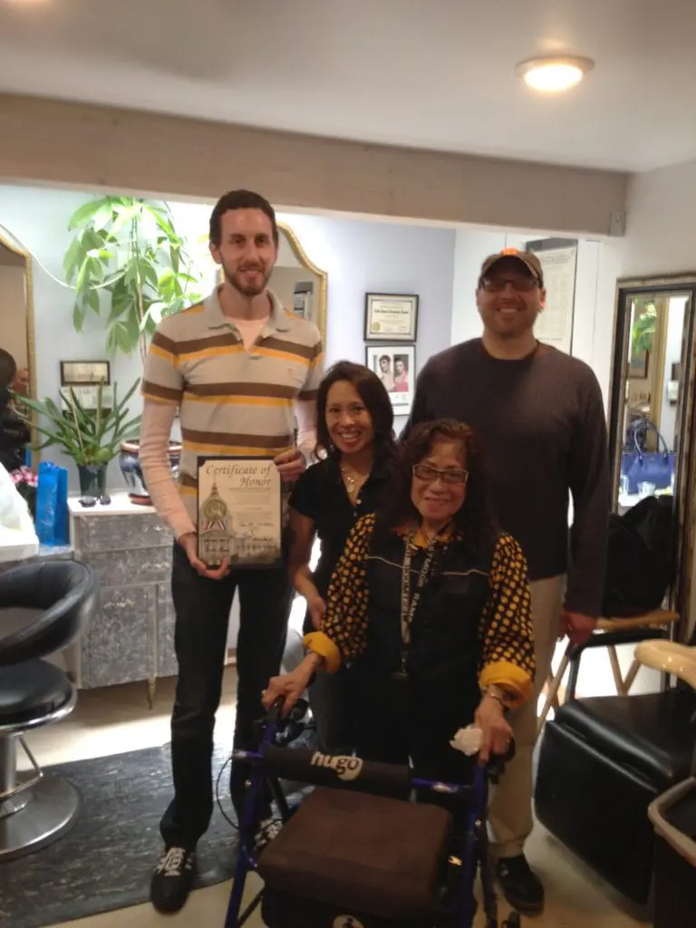 Scott Wiener presents Glory Dalere a Certificate of Honor for 45 years of service to Glen Park. Friends and family, including her daughter, Marian, and Ric Lopez, president of Glen Park Merchants Association look on. Photo taken at Dalere's Beauty Salon on Chenery Street on June 8. Photo by Murray Schneider.