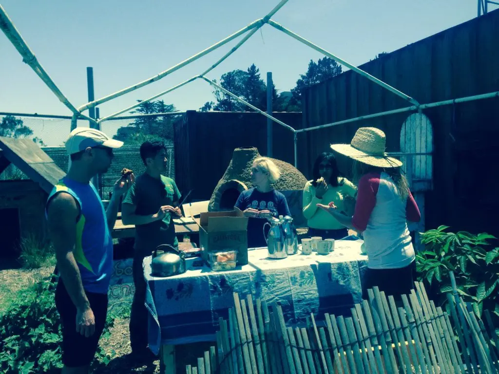 Tori Jacobs (her back turned and in a sun hat) enjoying snacks with several ECOSF volunteers.