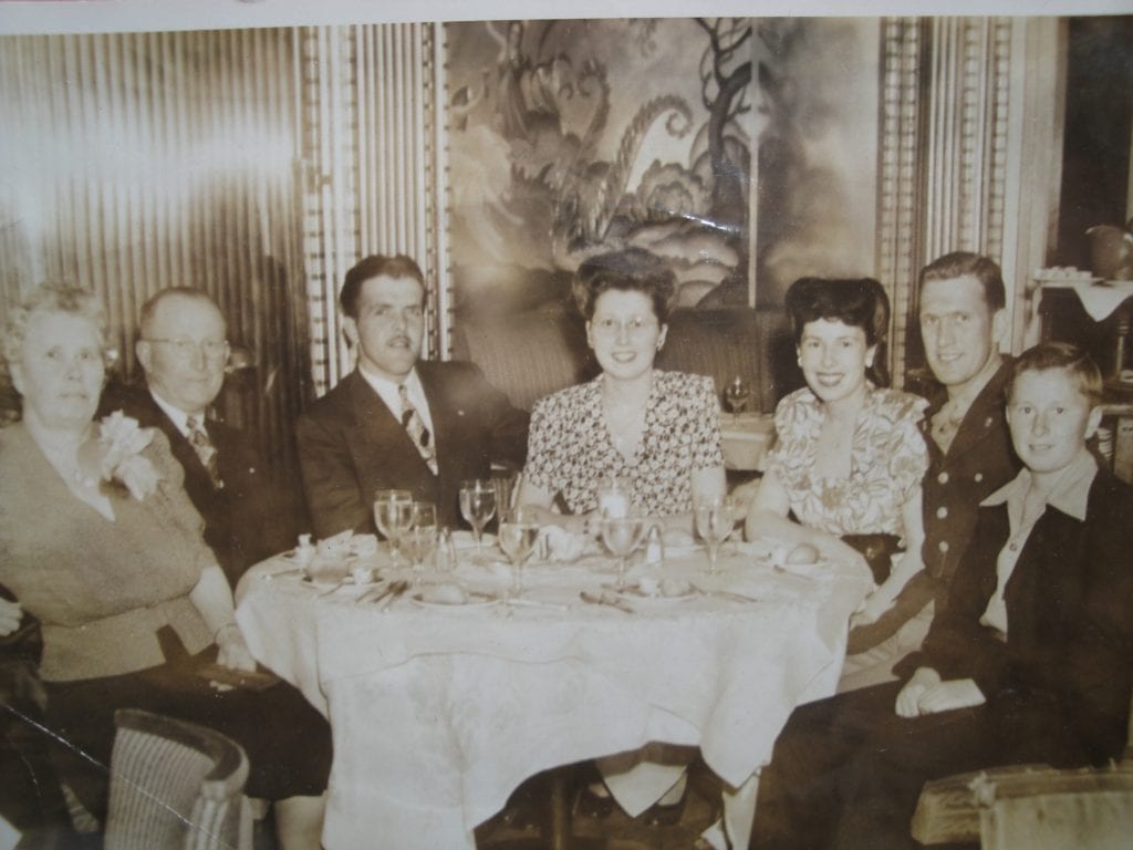 The Mickelsen family in a restaurant in the 1940s. The couple in the center are Evelyn and her husband. There is a young Ron Mickelsen there and on the left Chris and Anna Mickelsen.