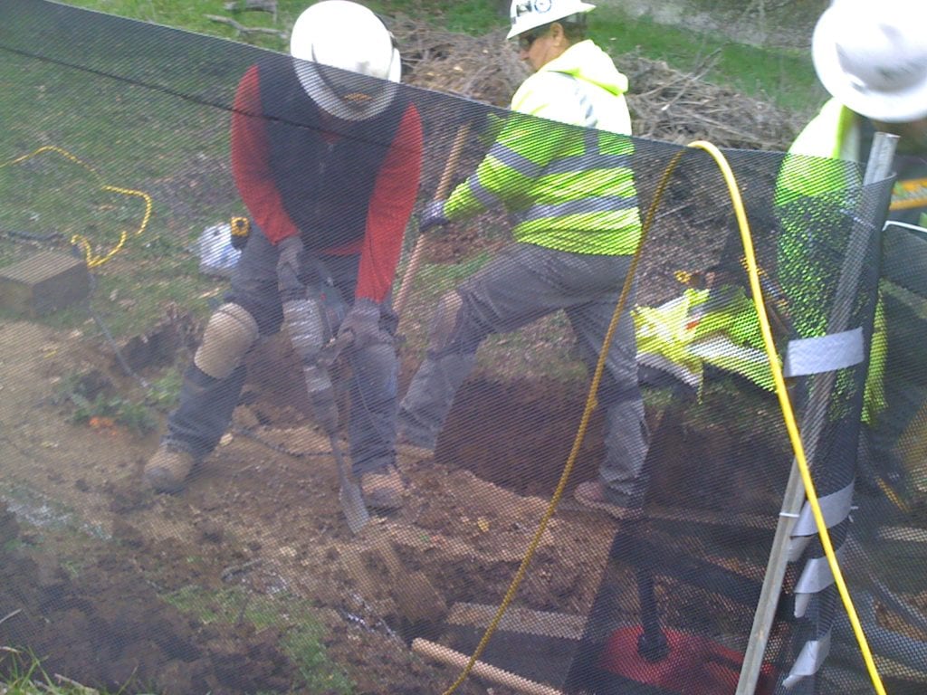 Workers creating the base for a stair step.