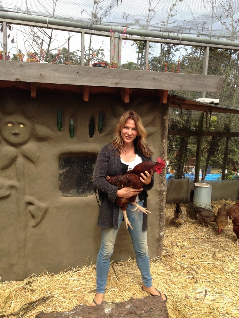 Tori Jacobs hold Jesse James, the Academy of Arts and Sciences rooster. Jesse is responsible for watching over 22 hens!