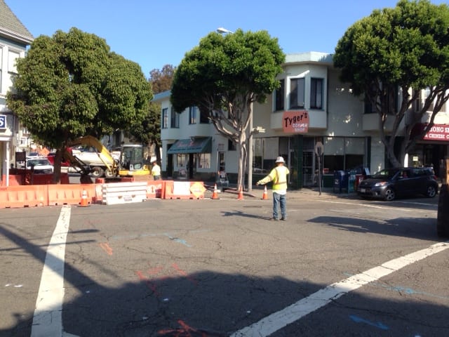 City worker directing traffic at the intersection of Chenery and Diamond Streets.