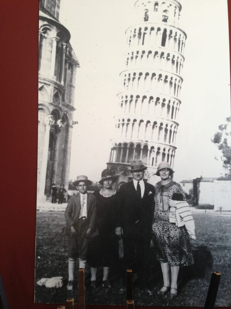 Raymond Ardiana stands next to his mother, Gialina. Behind them leans the Tower of Pizza. The Ardiana traveled back to their ancestral homeland in 1926, the year this photograph was taken. The other couple remains unidentified.