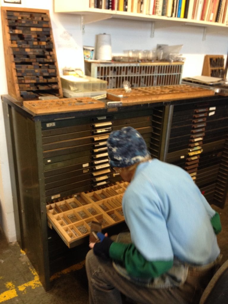  Mary selecting type for 40 Christmas cards. 