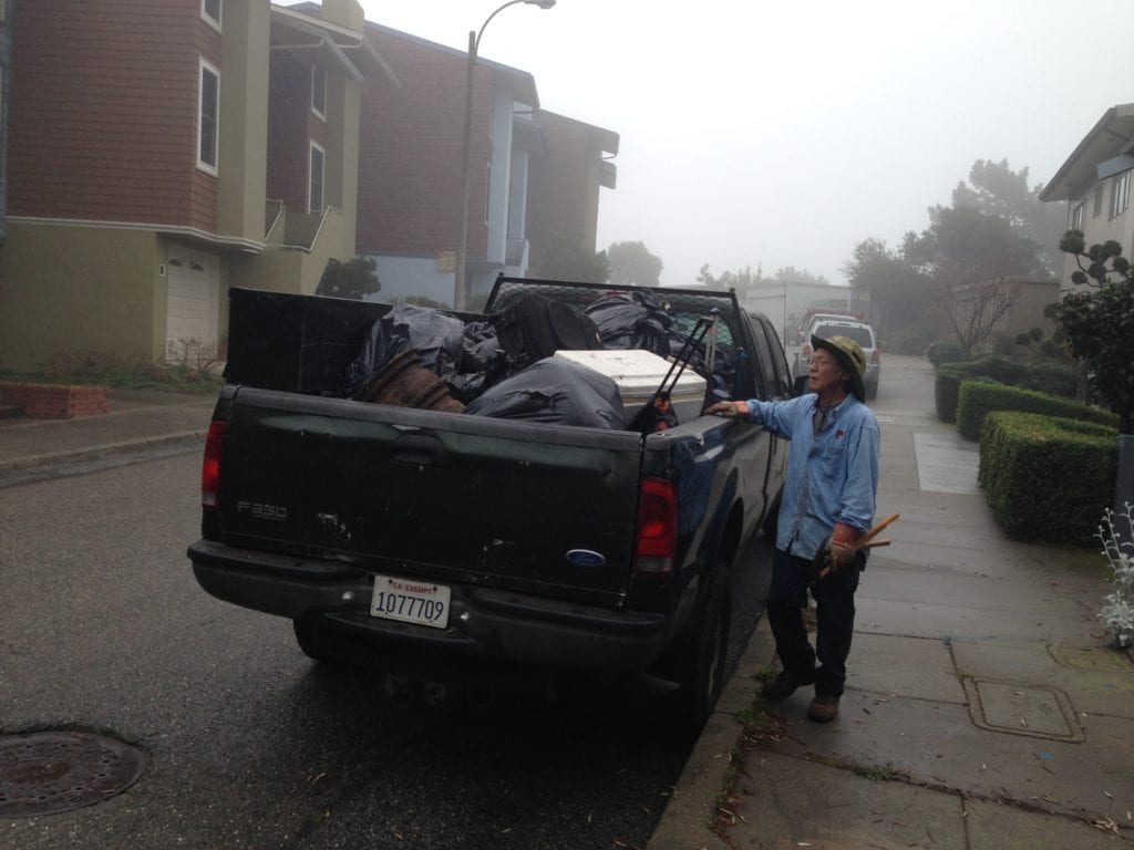 NAP volunteer, Steve Uchida, inspecting a truck only three-quarters filled with debris collected at a Glen Canyon homeless campsite. Altogether 660 pounds of debris would fill the Rec and Parks truck, awaiting removal to Recology's Tunnel Road waste management facility.