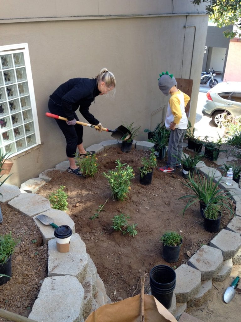 Diana Scearce does the digging while her son, Miles supervises.