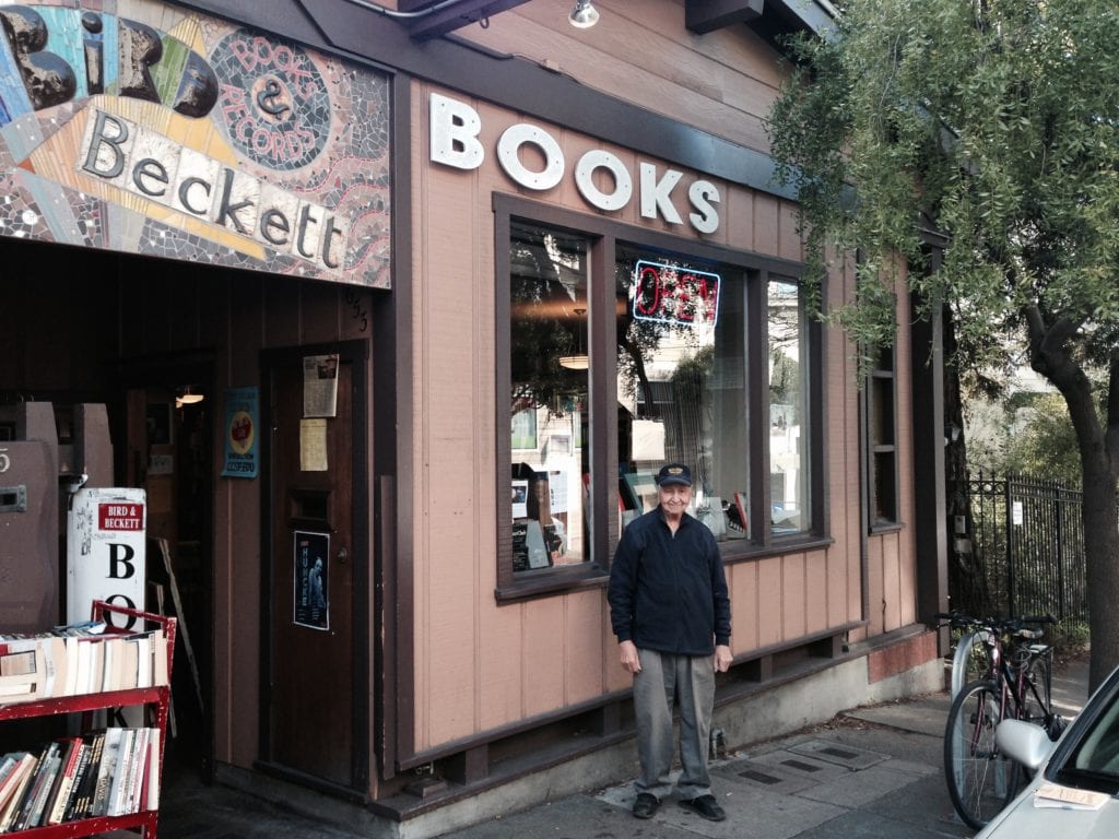 Ernie Solon standing in front of sign he had a hand in creating for Glen Park Hardware.