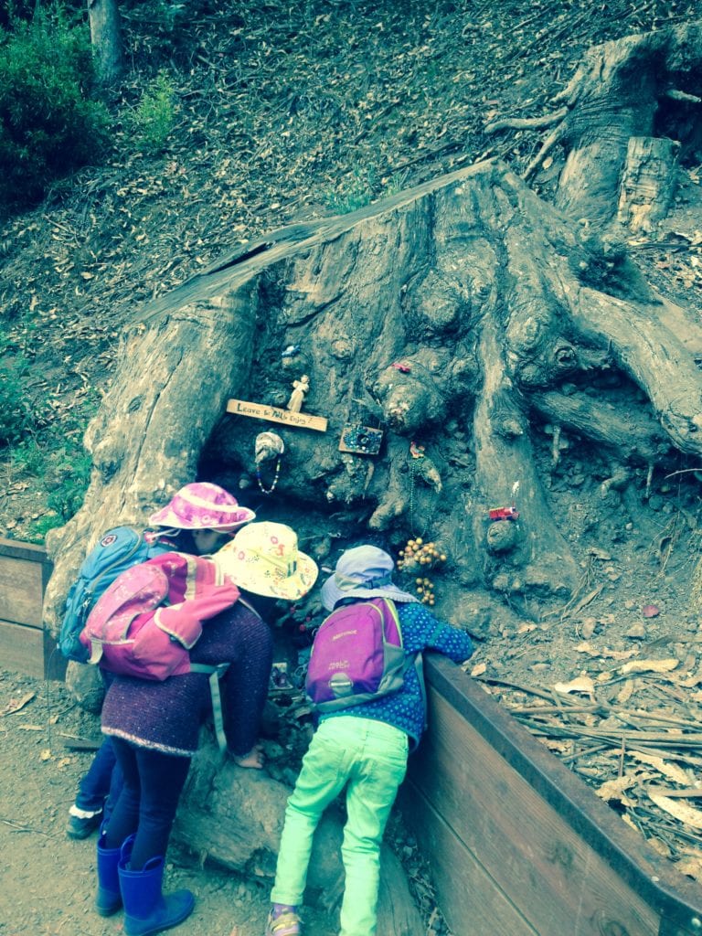 Three 4-year-olds inspecting the gnomes' house.