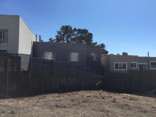 Backyards of Arlington Street houses adjacent to property.